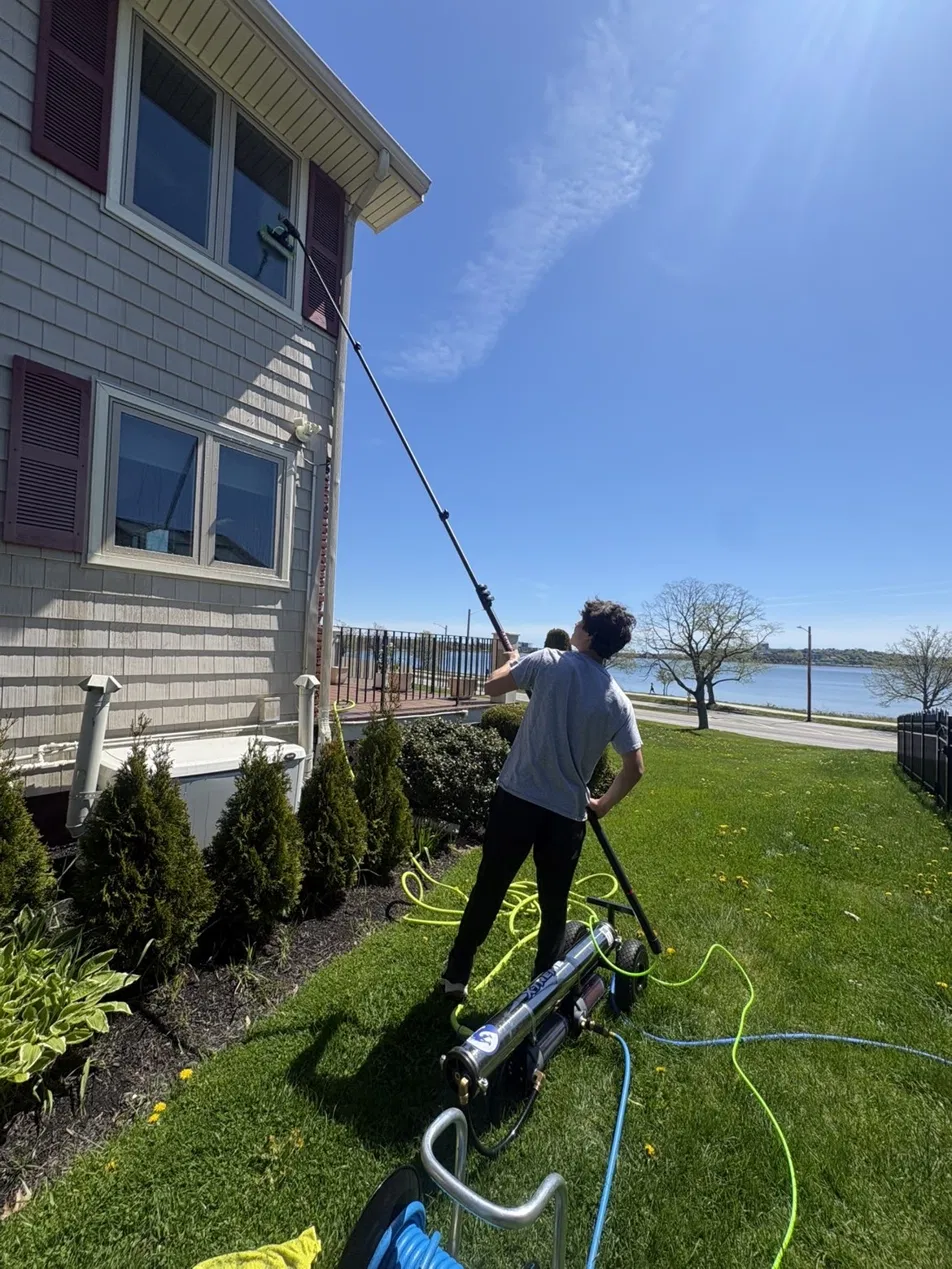Bulldog Windows cleaning second-story windows with a water-fed pole in Portland, Maine